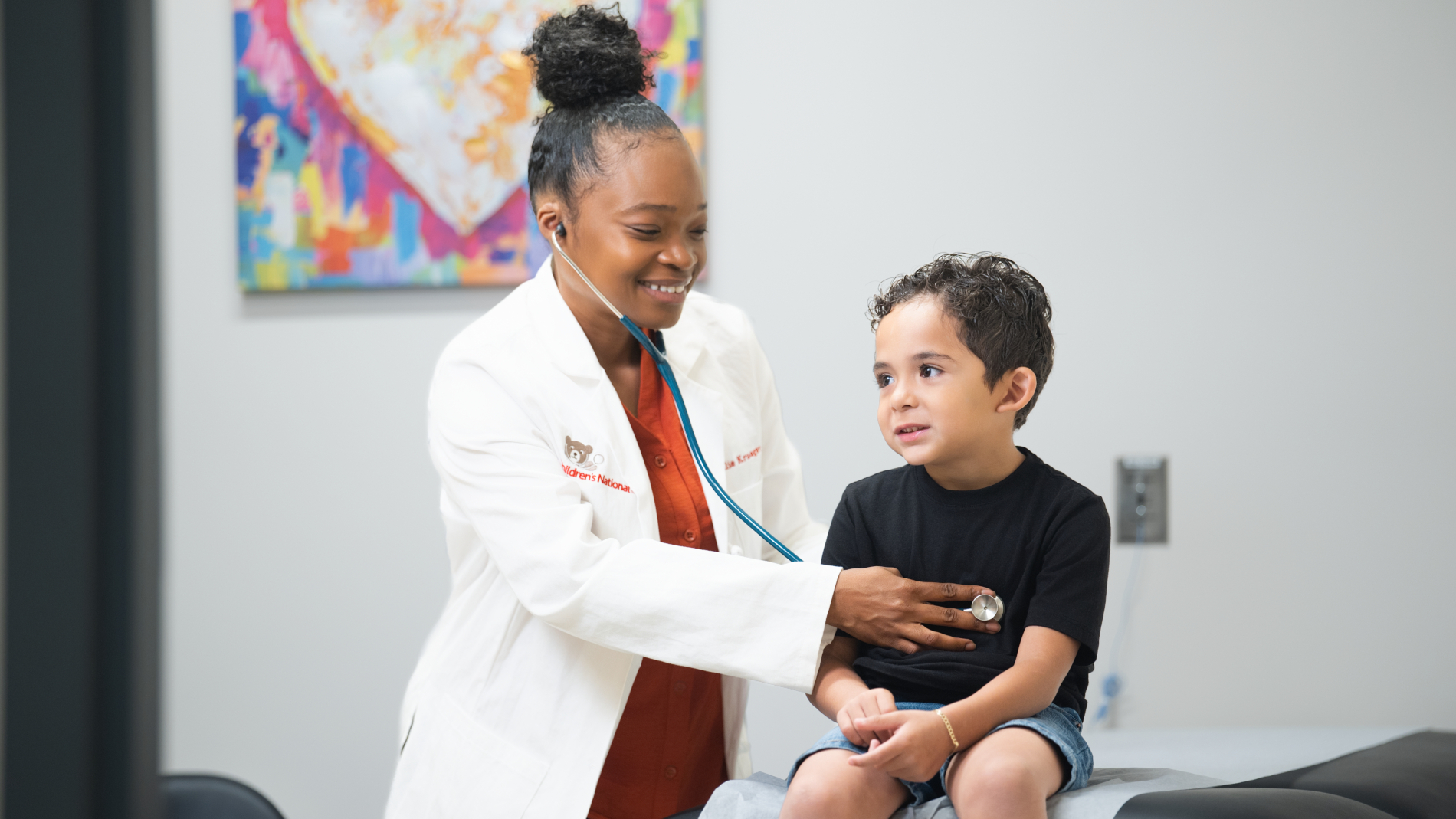 Doctor listens to child's heart