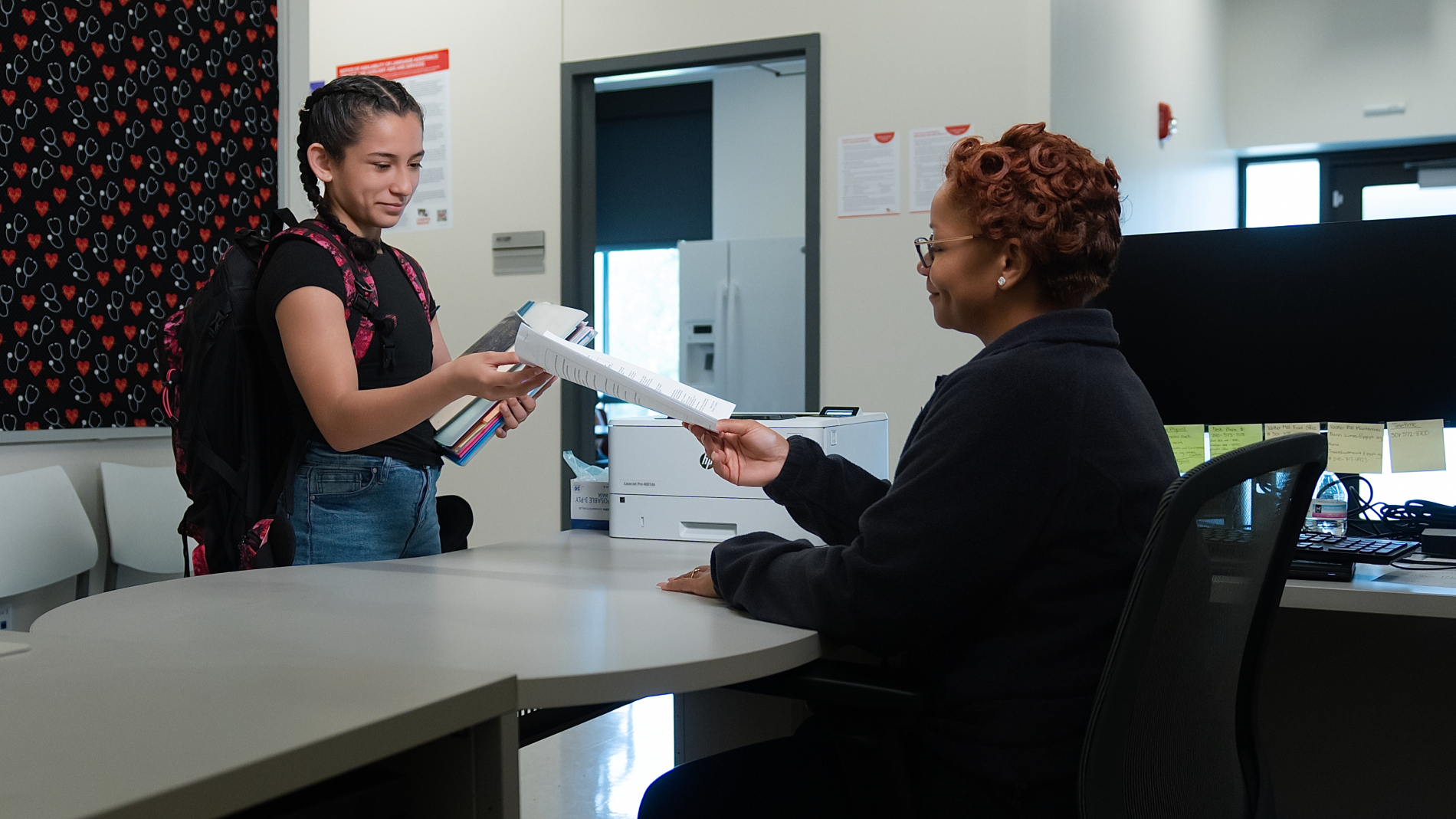 adolescent at reception desk