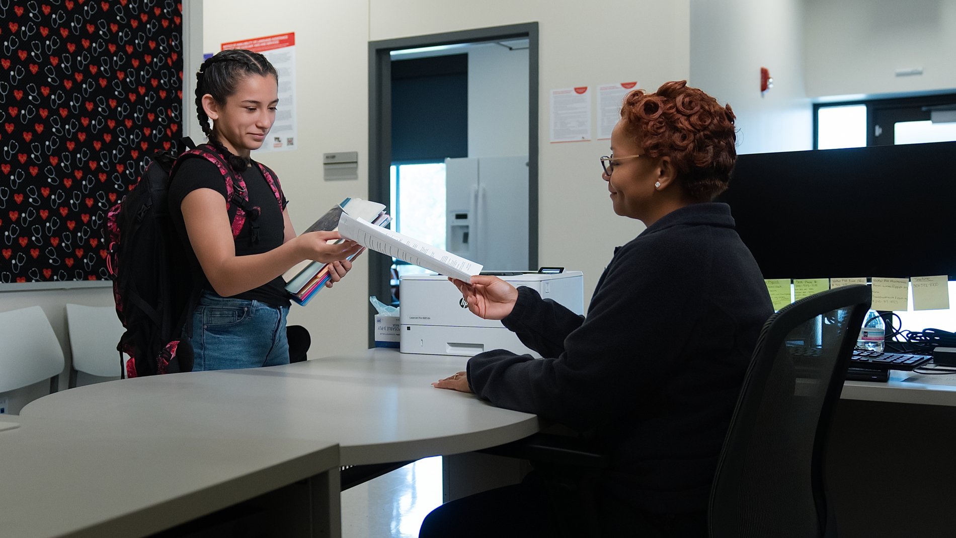 adolescent at reception desk