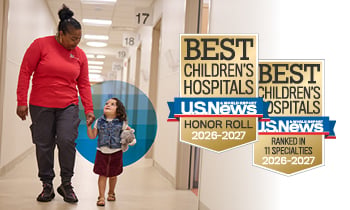 U.S. News & World Report - Best Children's Hospitals: Honor Roll and Ranked in 11 Specialties 2025-2026 badge with an image of a baby girl in a yellow outfit smiling and sitting on the floor.