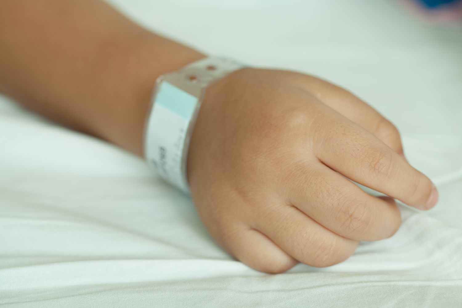 Child's hand with a medical bracelet