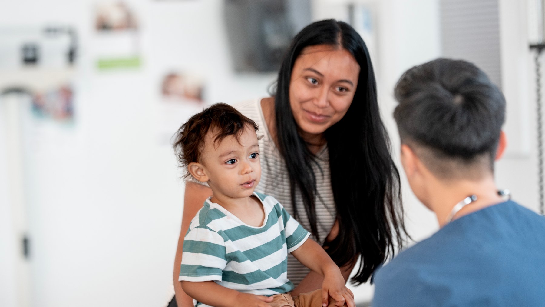 mother and young child consult with doctor