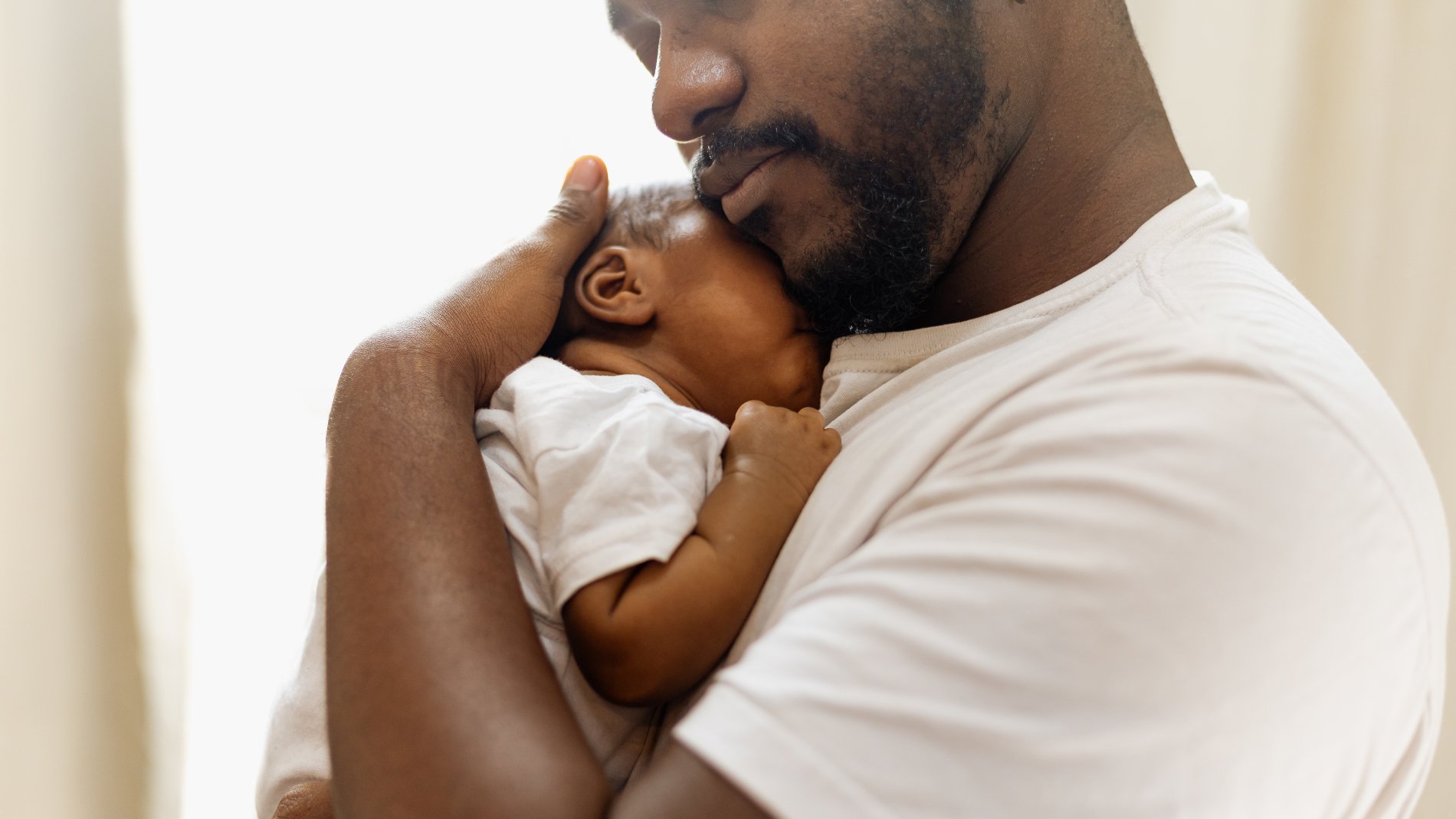 Father hugging infant