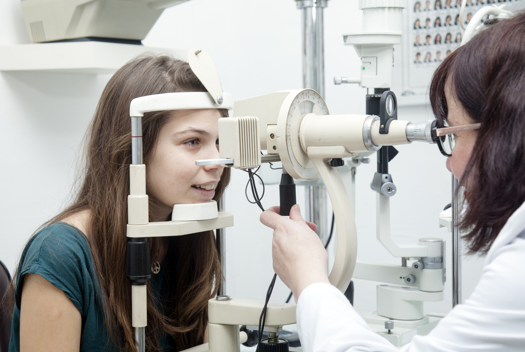 doctor examines kid's eyes