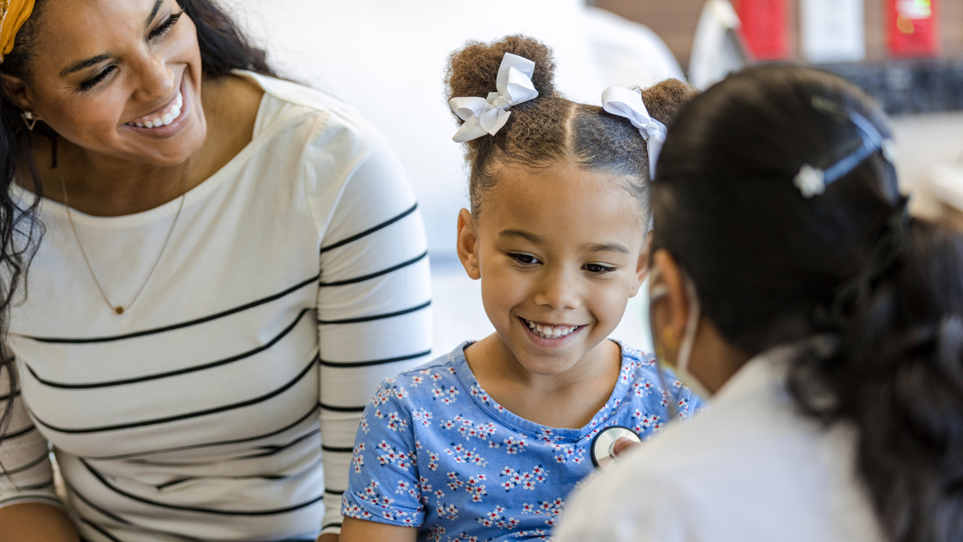 healthcare provider listening to girl's heart