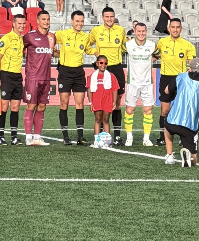 Children's National patient ambassador on Loudoun United FC field.