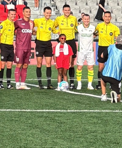 Children's National patient ambassador on Loudoun United FC field.
