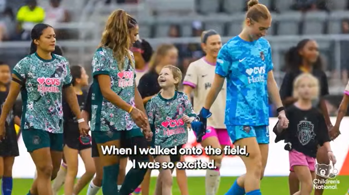 Children's National patient Taylor joins Washington Spirit players on the field at a game