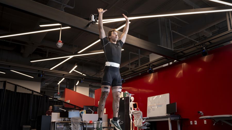 Sports Performance and Motion Analysis Lab patient stretches with censors on his body.