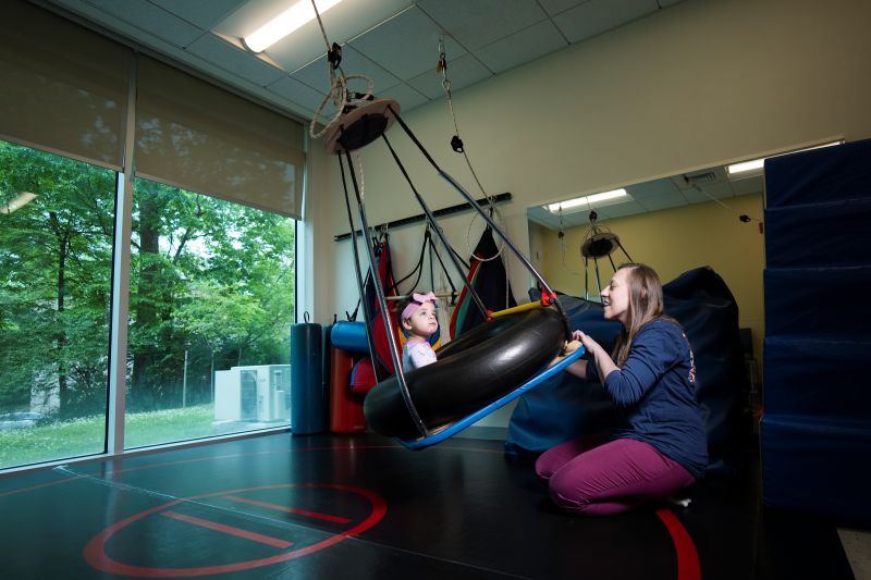 Young patient on swing in therapy