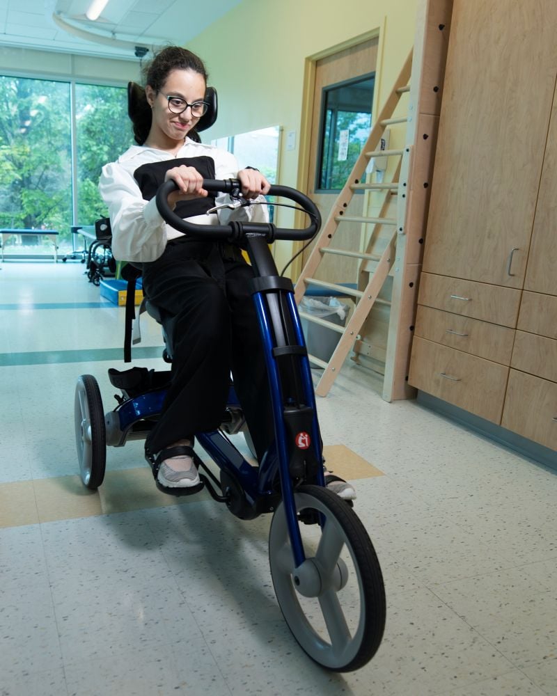 Young patient cycling in therapy