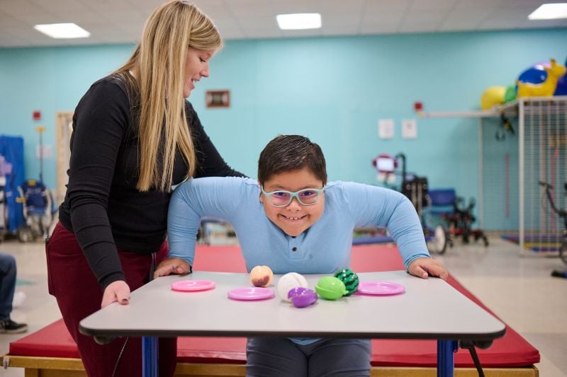 Young patient in therapy working on movements