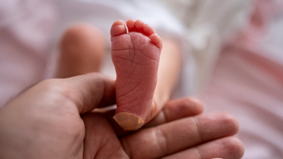 newborn baby with bandaid on heel
