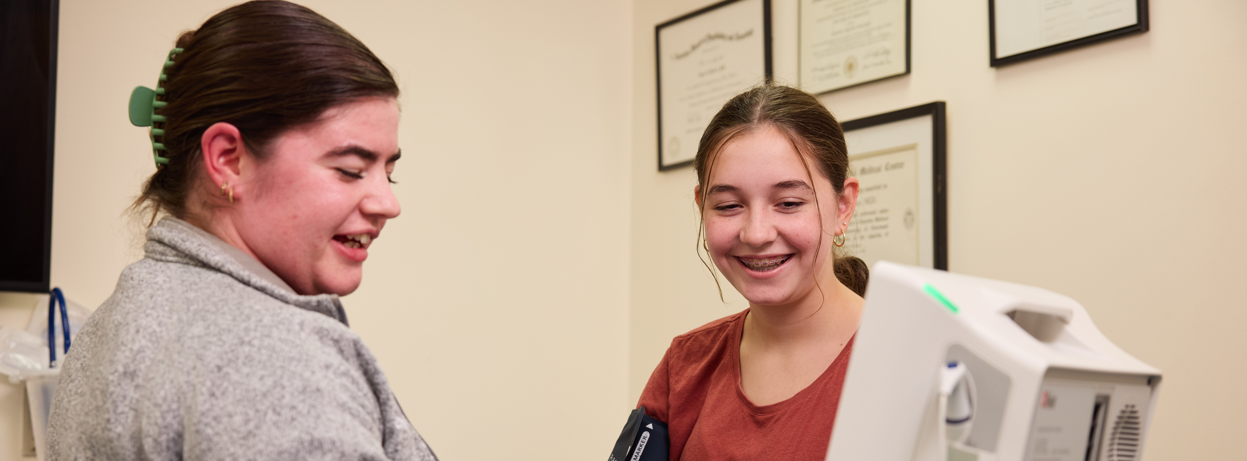 healthcare provider and smiling teen girl