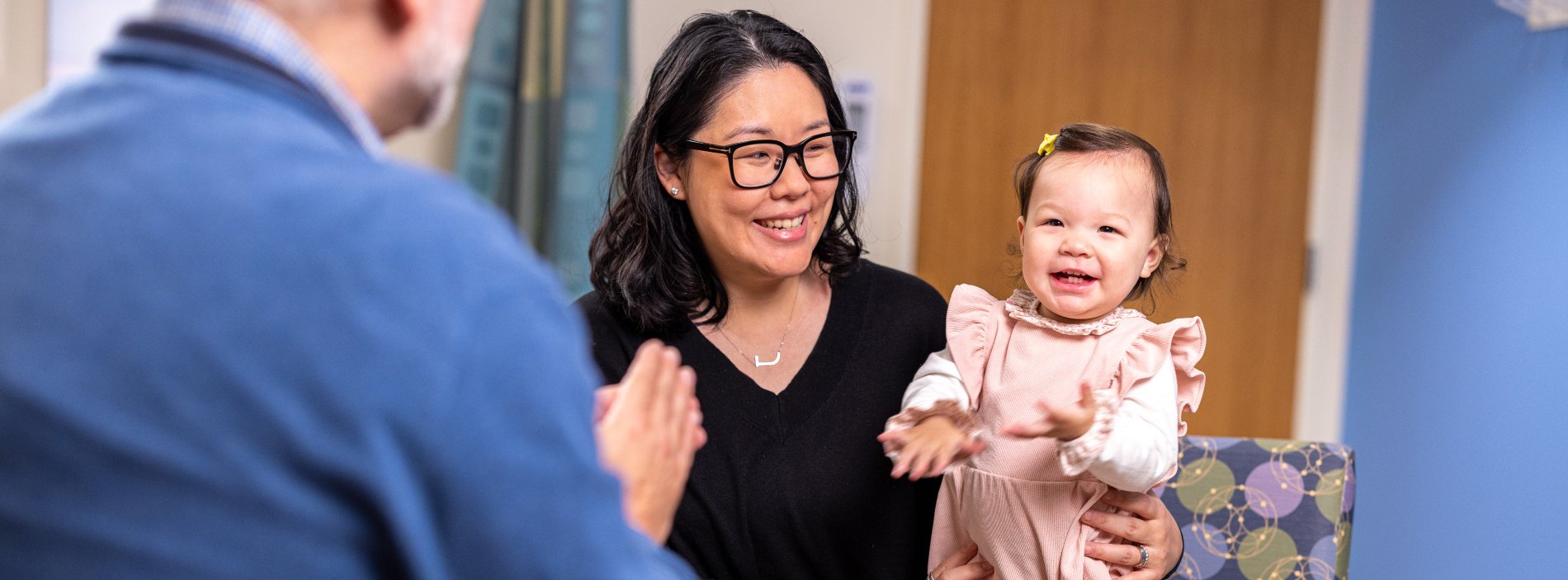 mother with doctor and smiling baby girl