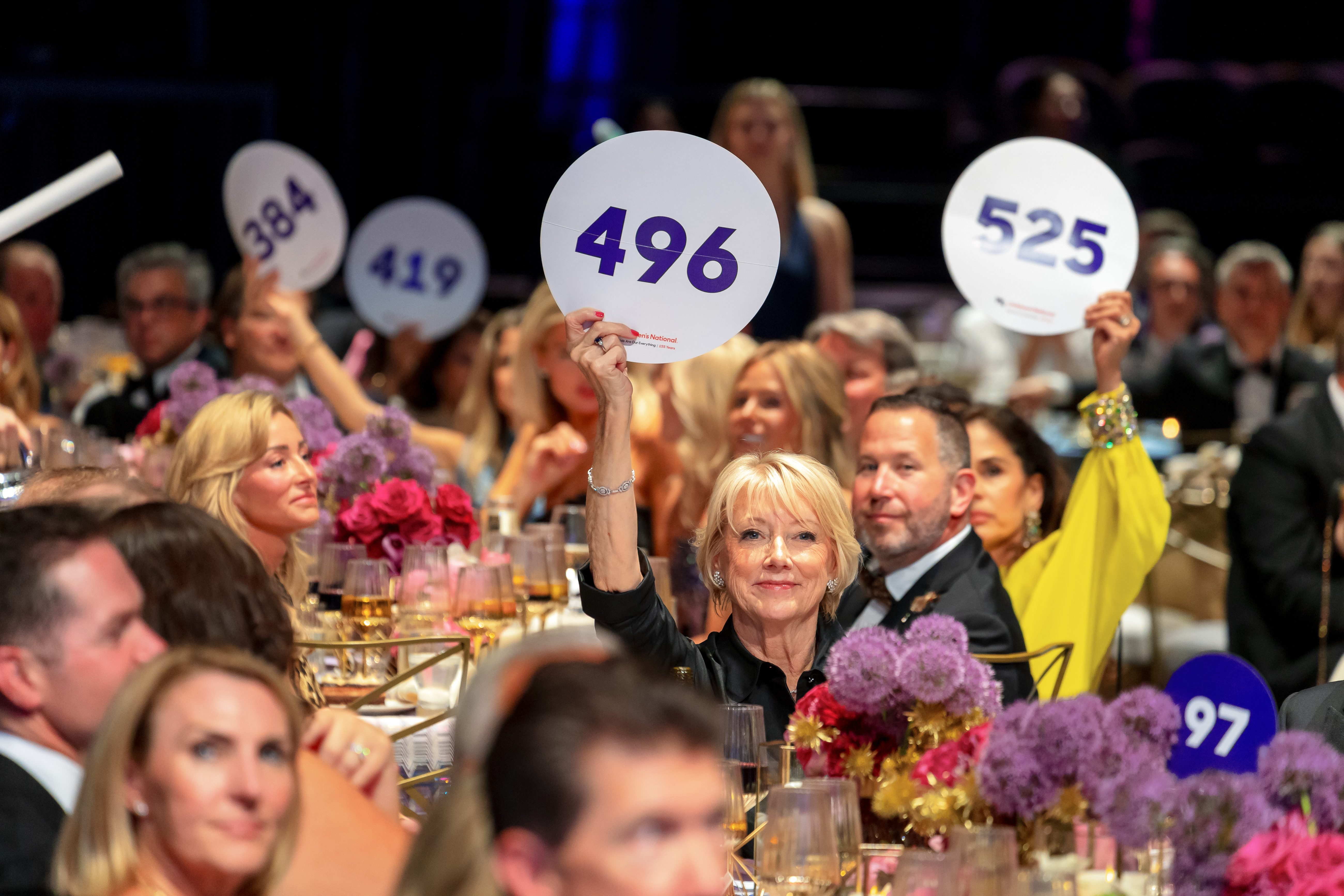 Event attendees participate in an auction at the Children's Ball 2026.