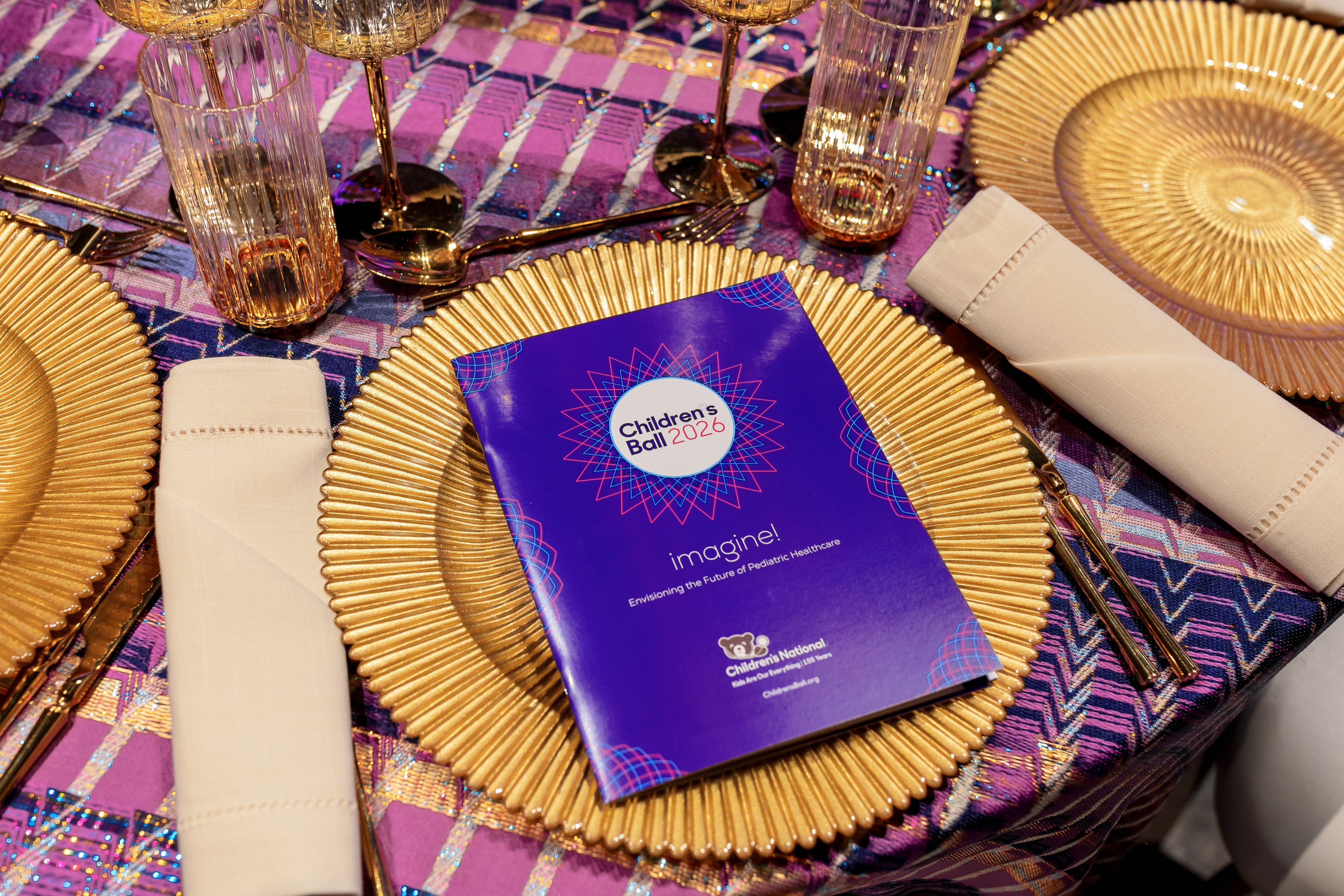 Children's Ball 2026 place setting with printed event information.