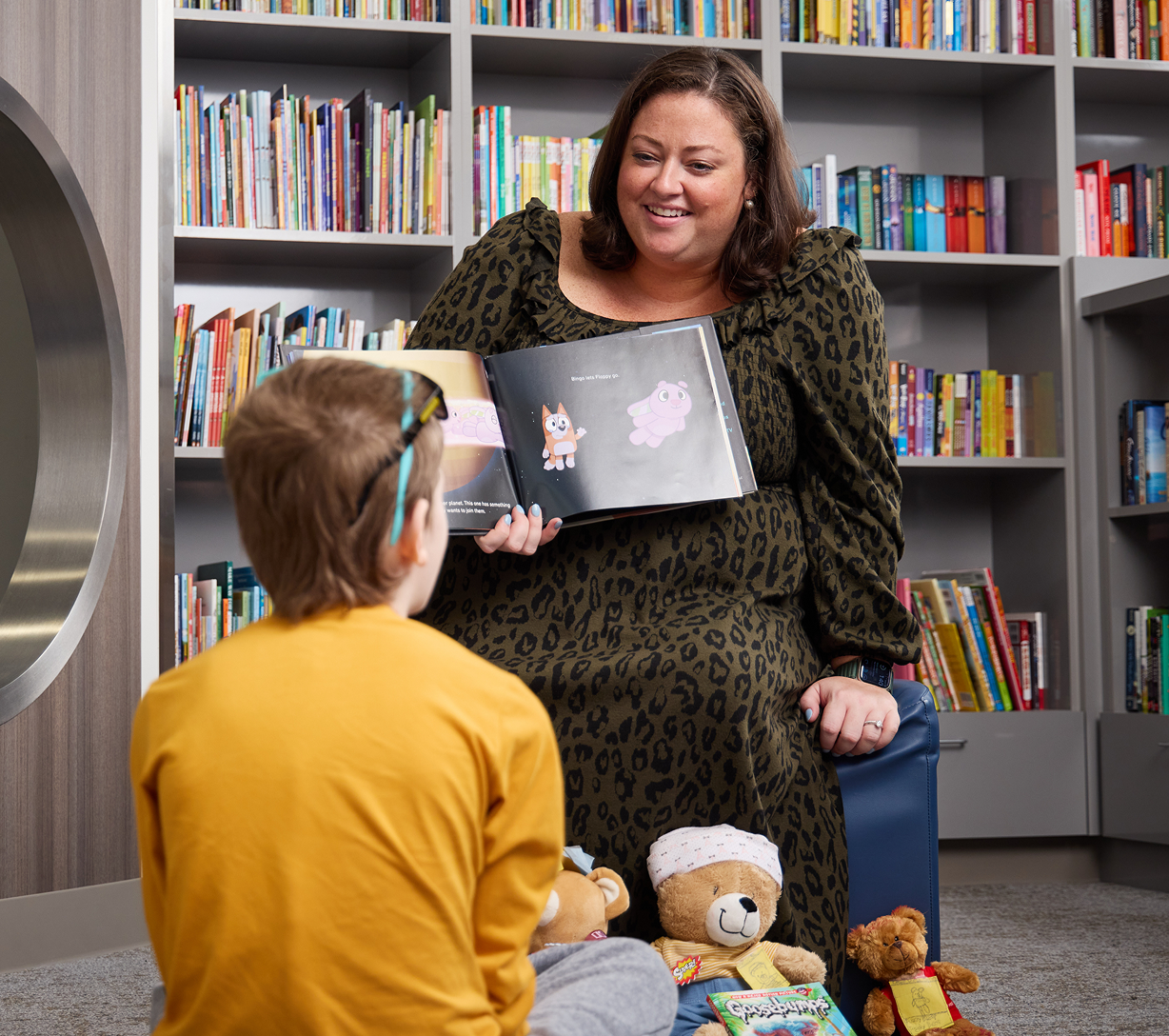 Allie Slocum reading to a patient.