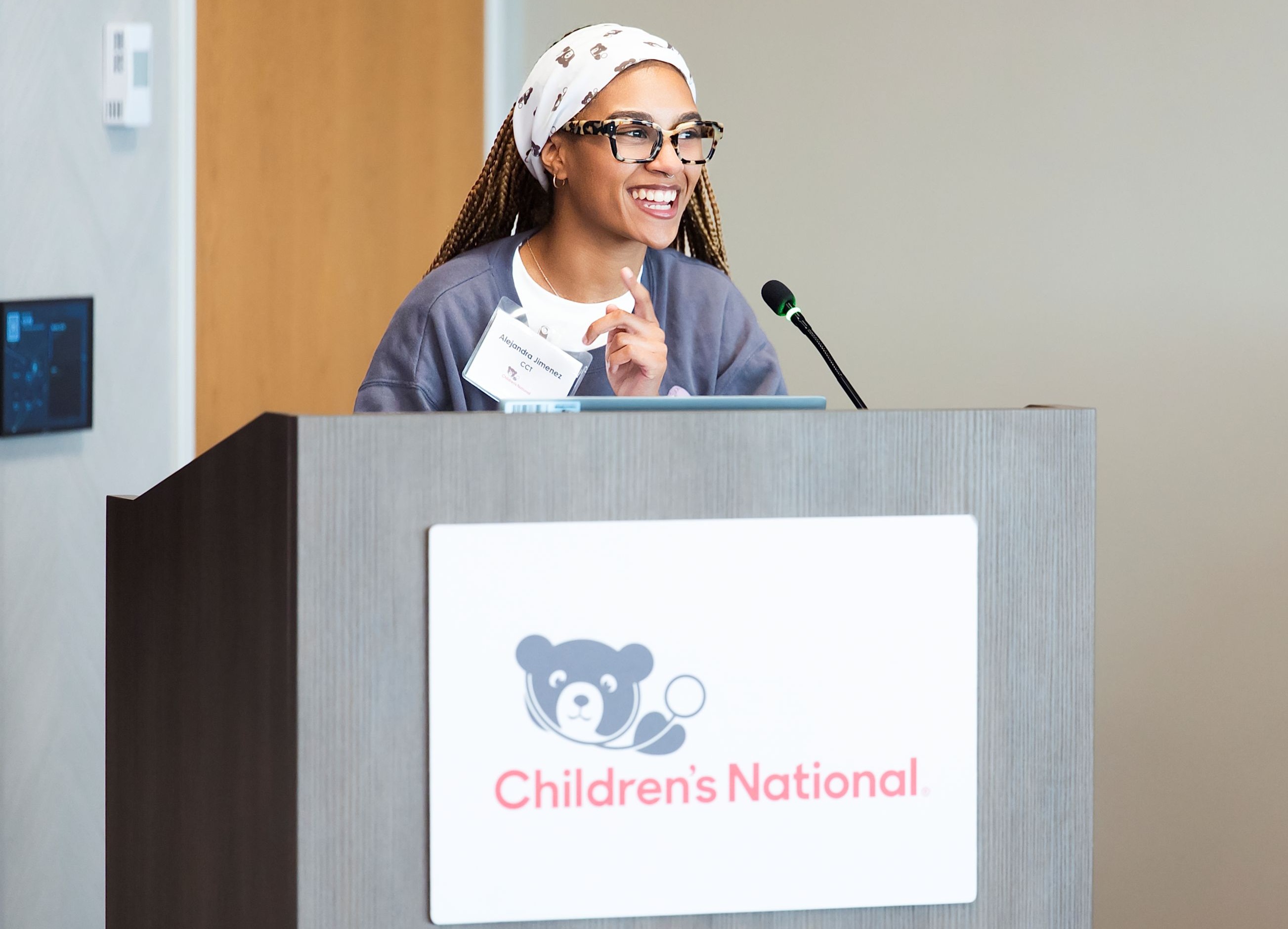 Alejandra Jimenez speaking at a Children's National branded lectern.