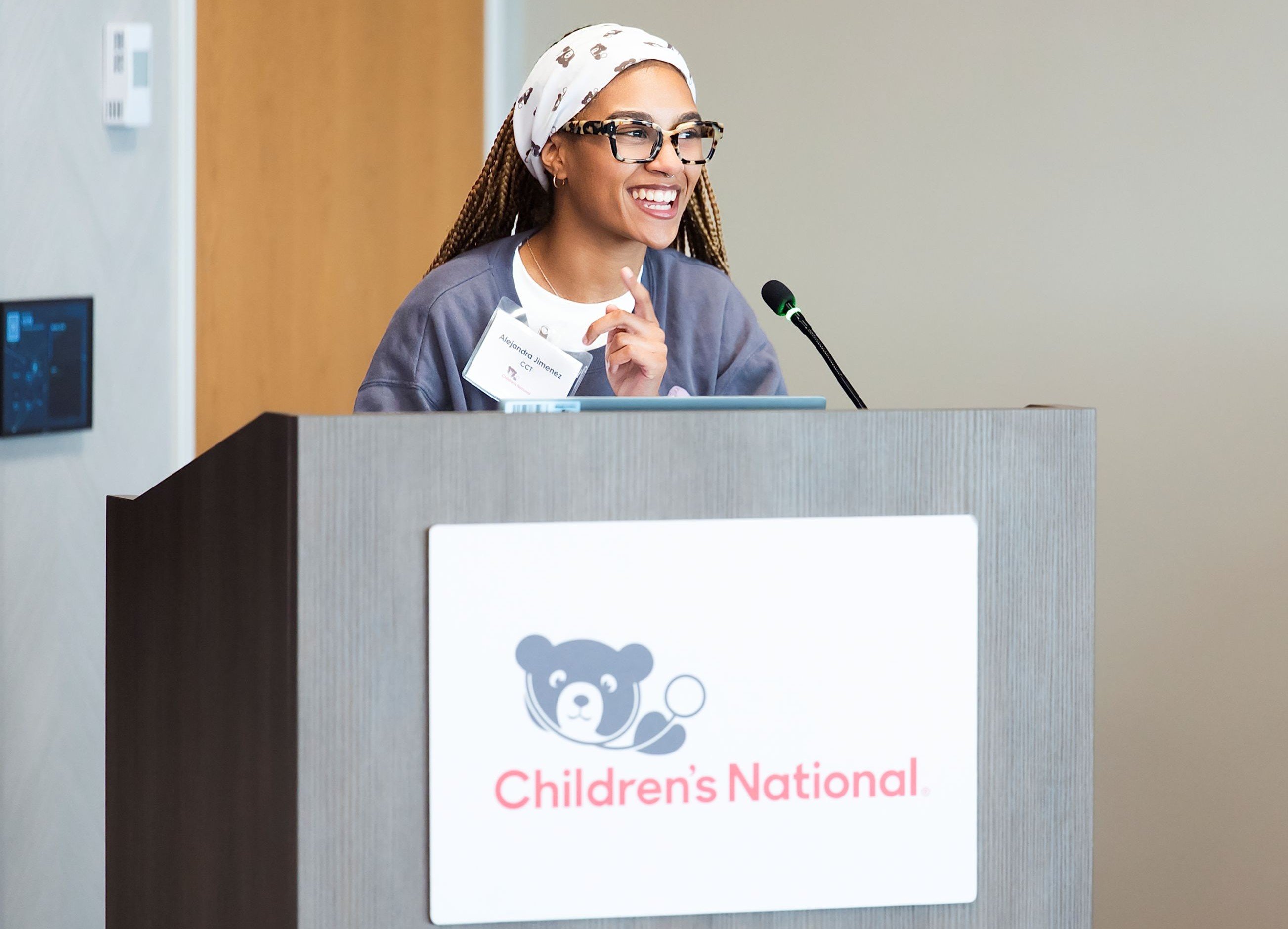 Alejandra Jimenez speaking at a Children's National branded lectern.