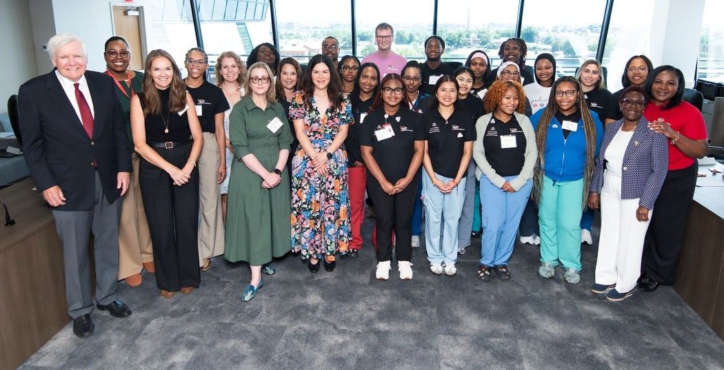 Alejandra Jimenez poses for a photo with Mr. Conway and her Conway Nursing Pathway Program cohort.
