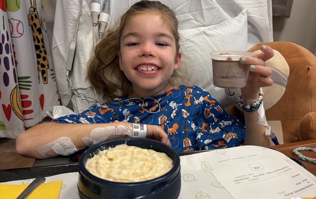 Alice excited to eat macaroni and cheese as a patient at Children's National.