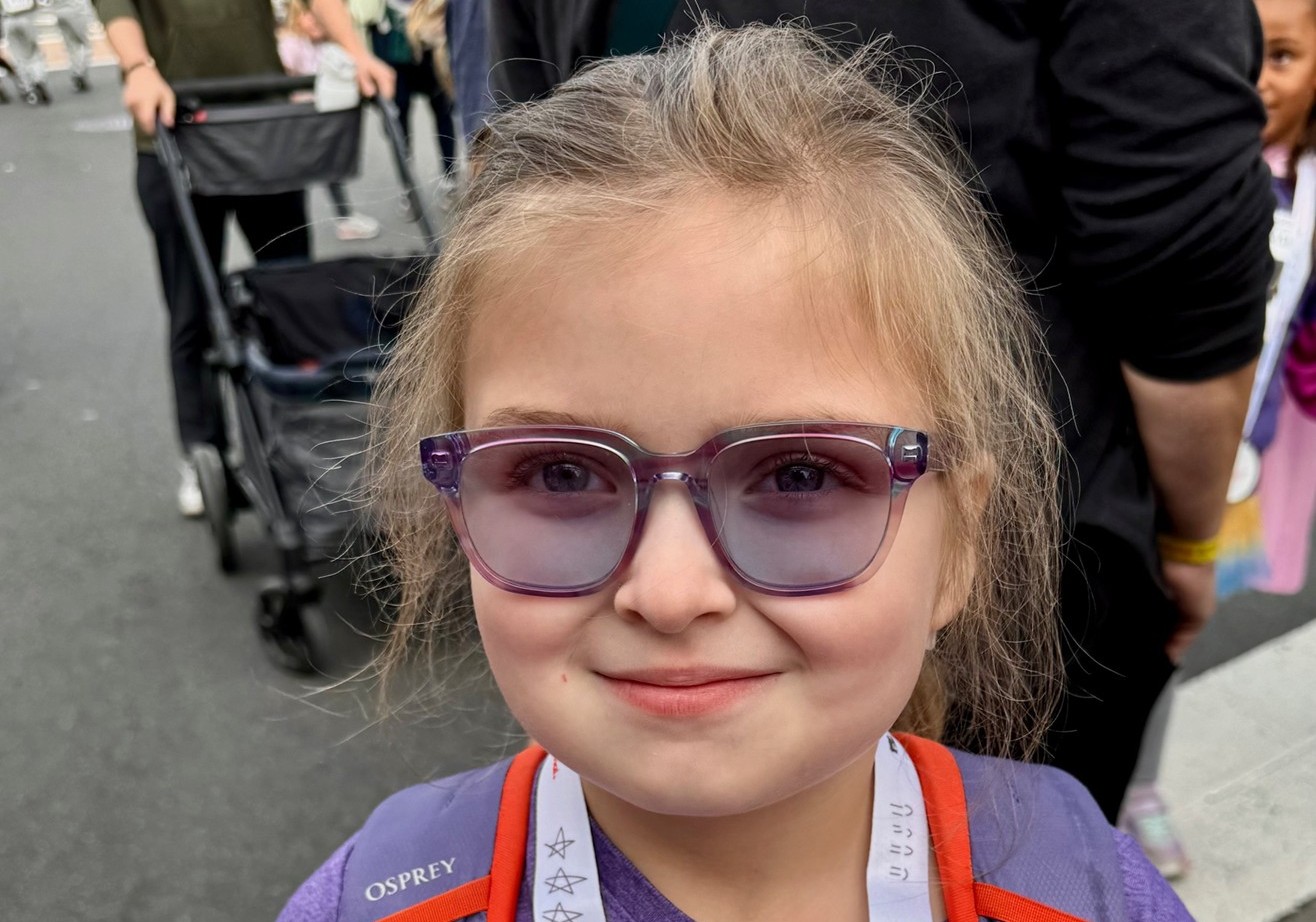 Ellie posing with her 2025 Kids Dash medal.