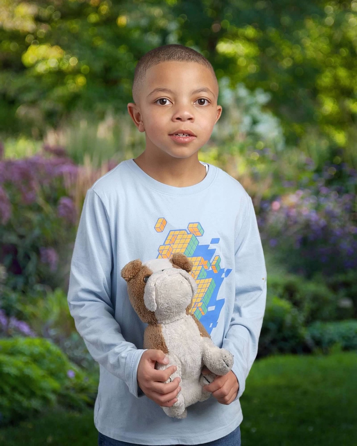 Nemo as an older child holding a stuffed animal toy.