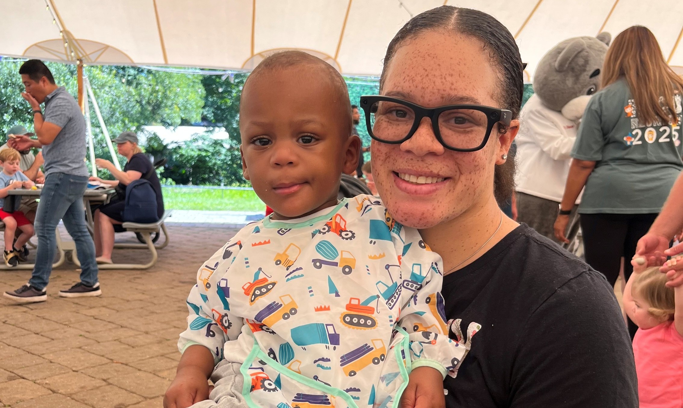 Trace as an older and healthier child poses with his mother at a NICU reunion event.